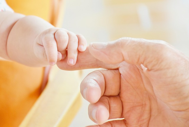 baby's hand gripping adult's index finger to highlight the issue of inadequate maternity services leeds