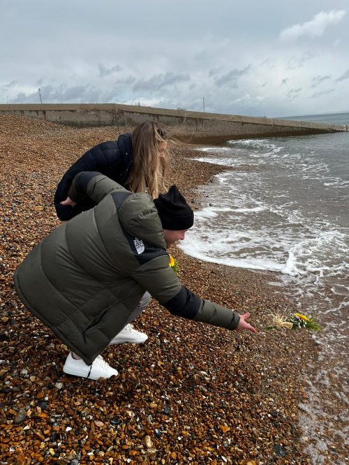 Chloe and Toby lay flowers at the shoreline in memory of Esme