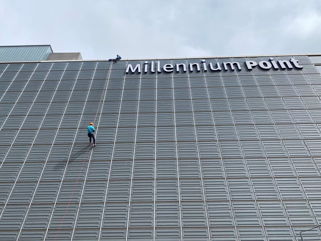 Member of the team abseiling down Millennium Point