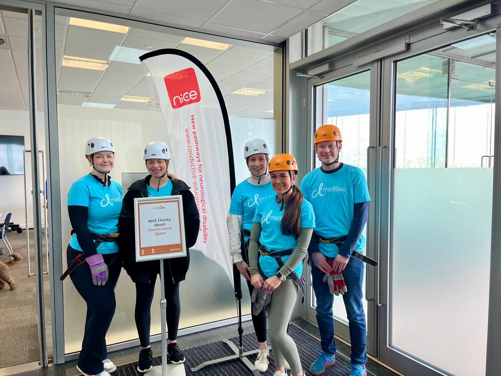 The CL Medilaw abseil team with the NICE charity banner