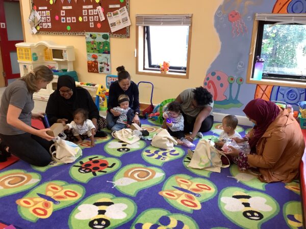 Pictures of children playing on a play mat with adults supervising beside them