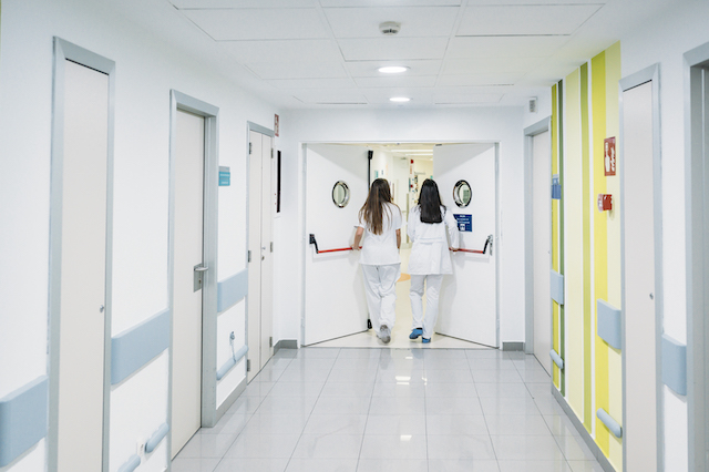 two nurses walking along hospital corridor to highlight issues requiring medical negligence solicitors cambridge