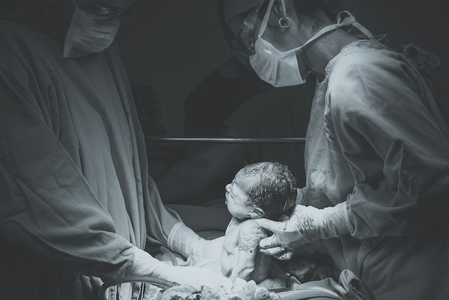 black and white image of baby being born to highlight the issues at the heart of the ouh maternity investigation