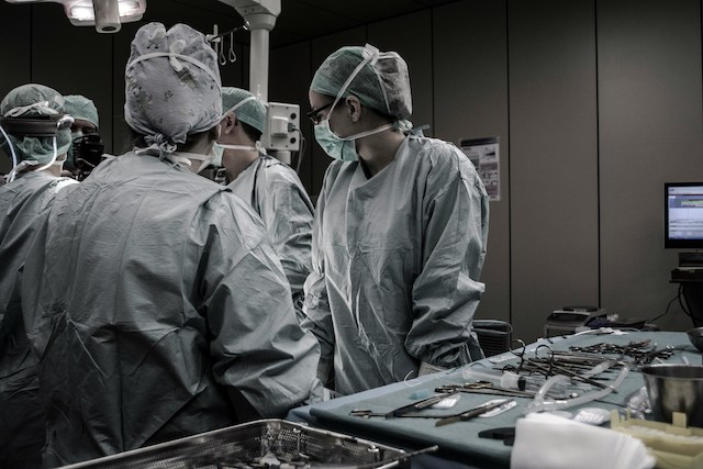 surgeons choosing instruments to highlight private health care vs public healthcare